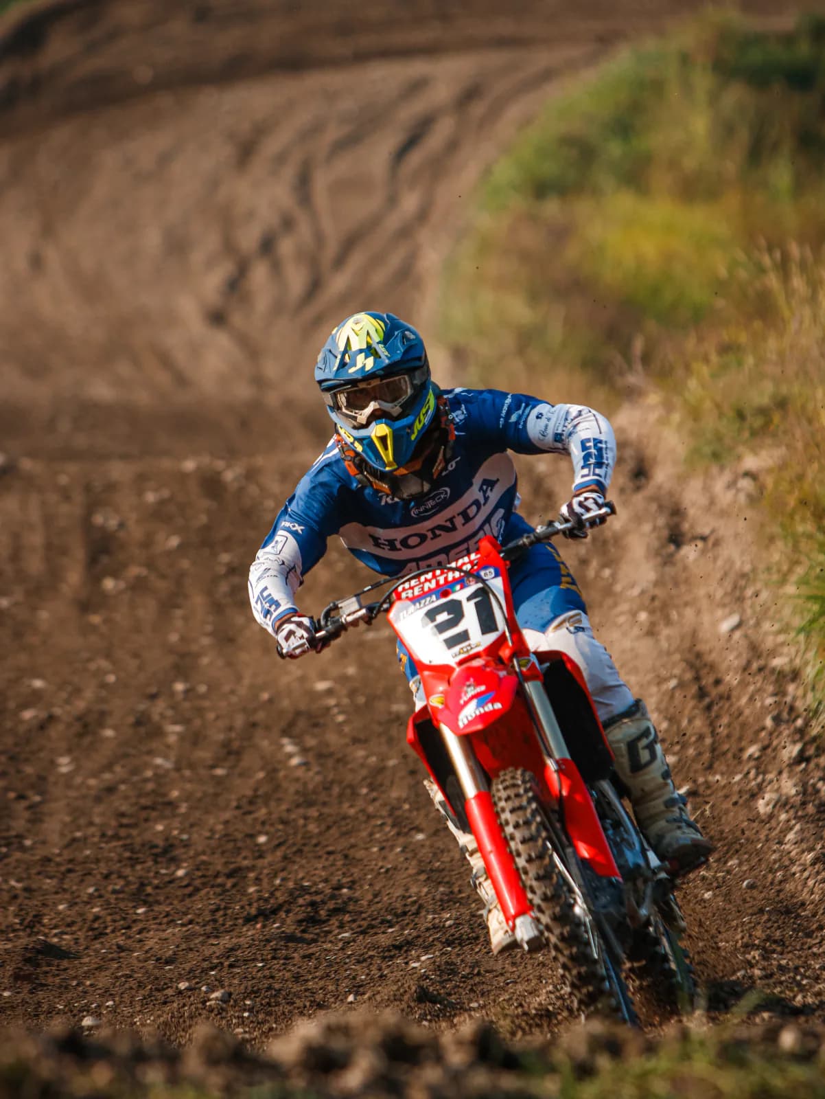 Motocross rider on a Honda cornering on dirt.
